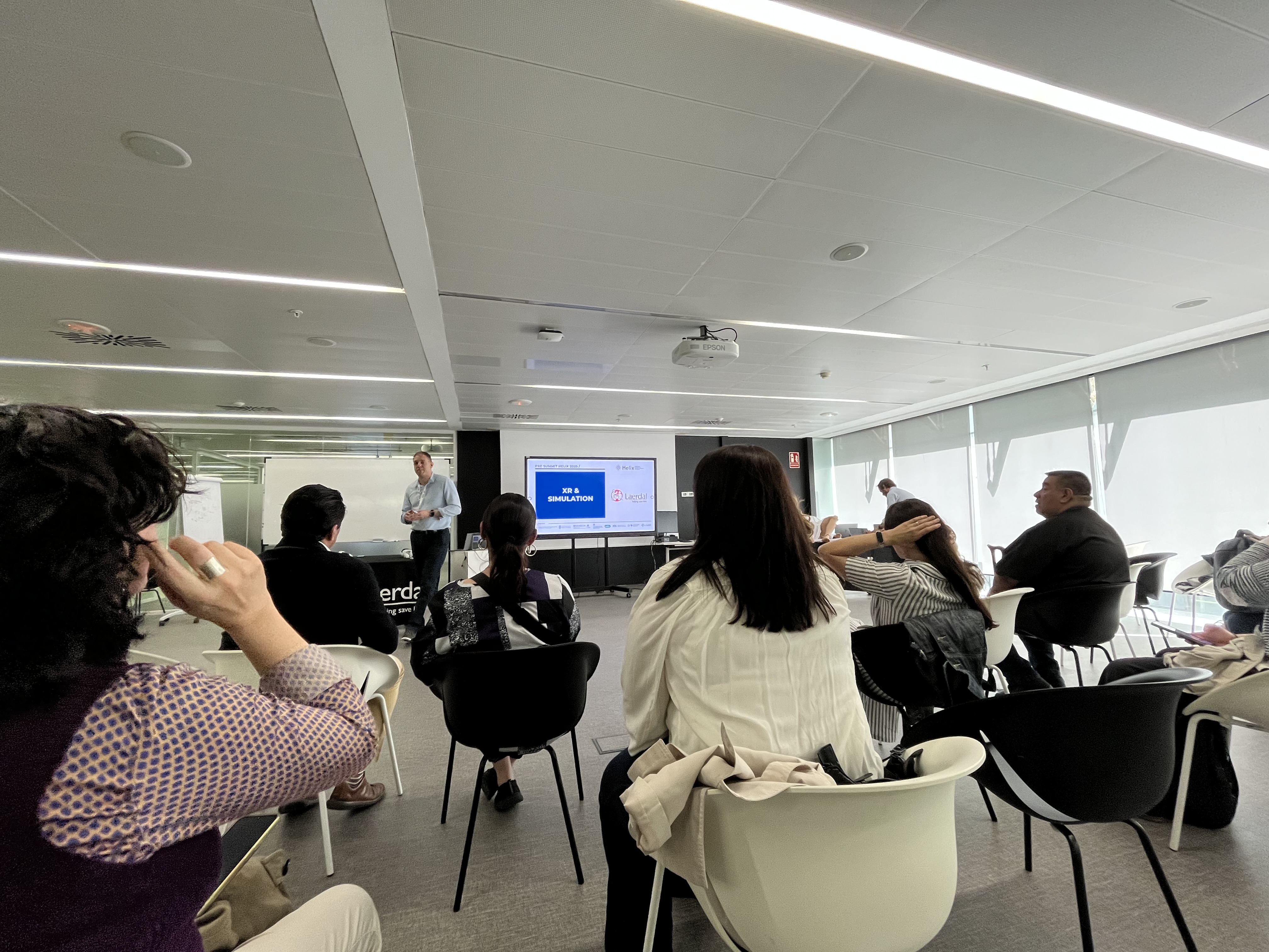 Healthcare staff at a conference, attending a lecture.